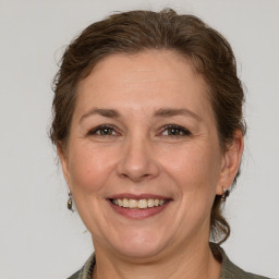 Joyful white adult female with medium  brown hair and grey eyes