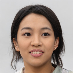 Joyful asian young-adult female with medium  black hair and brown eyes