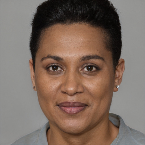 Joyful black adult female with short  black hair and brown eyes