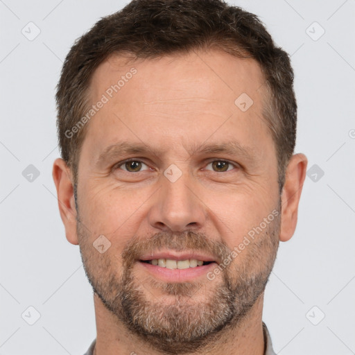 Joyful white adult male with short  brown hair and brown eyes