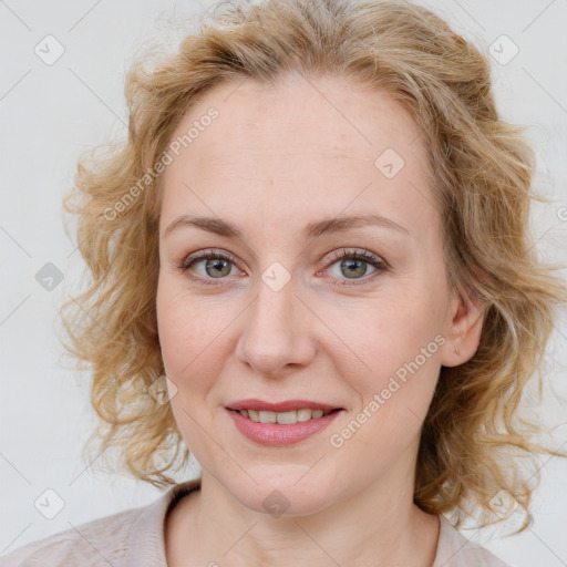 Joyful white young-adult female with medium  brown hair and blue eyes