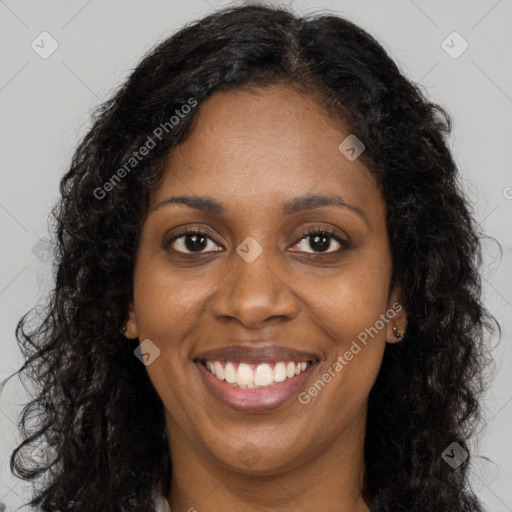 Joyful black young-adult female with long  brown hair and brown eyes