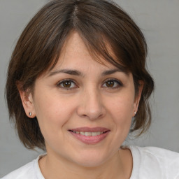 Joyful white adult female with medium  brown hair and brown eyes