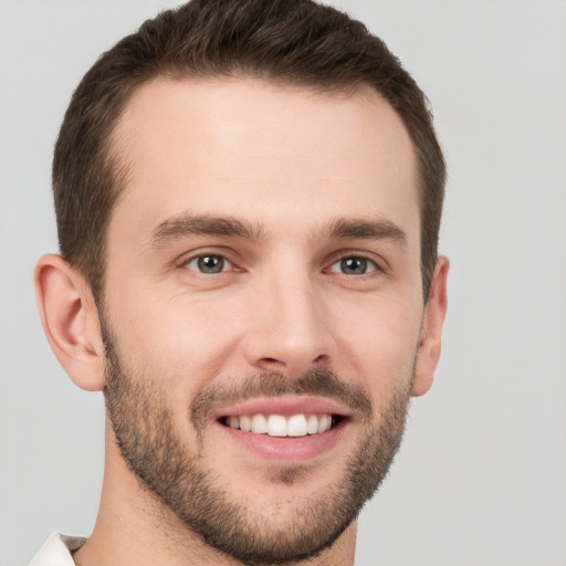 Joyful white young-adult male with short  brown hair and brown eyes