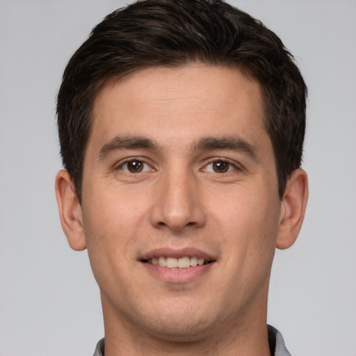 Joyful white young-adult male with short  brown hair and brown eyes