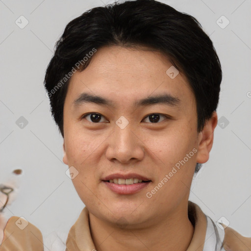 Joyful asian young-adult male with short  black hair and brown eyes