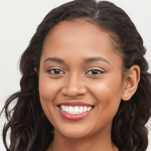 Joyful latino young-adult female with long  brown hair and brown eyes