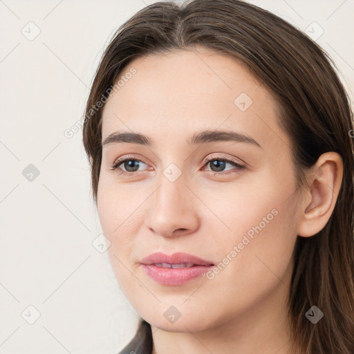 Joyful white young-adult female with long  brown hair and grey eyes