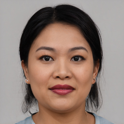 Joyful asian young-adult female with medium  black hair and brown eyes
