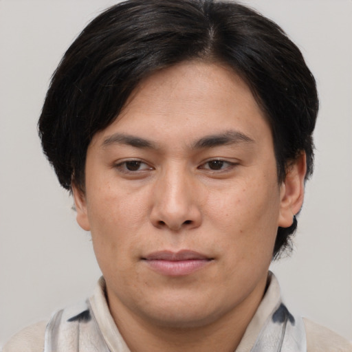 Joyful asian young-adult male with medium  brown hair and brown eyes