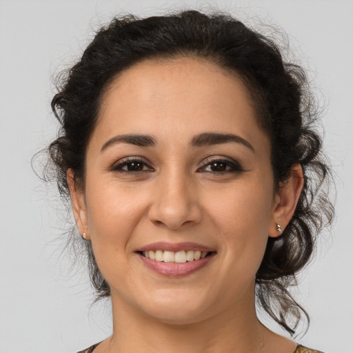 Joyful latino young-adult female with medium  brown hair and brown eyes
