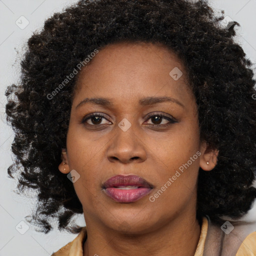 Joyful black adult female with medium  brown hair and brown eyes