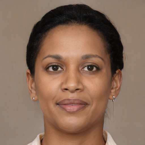 Joyful black young-adult female with short  brown hair and brown eyes
