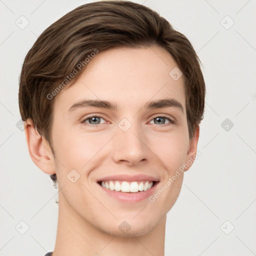 Joyful white young-adult male with short  brown hair and grey eyes