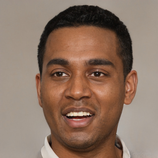 Joyful black young-adult male with short  black hair and brown eyes