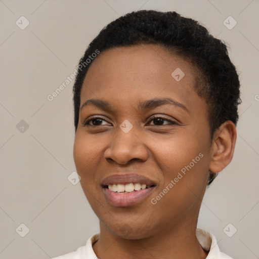 Joyful black young-adult female with short  black hair and brown eyes