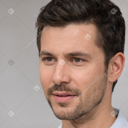 Joyful white adult male with short  brown hair and brown eyes