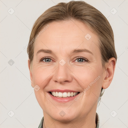 Joyful white adult female with short  brown hair and grey eyes