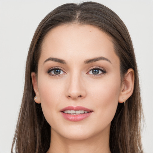 Joyful white young-adult female with long  brown hair and grey eyes