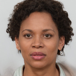 Joyful black adult female with short  brown hair and brown eyes