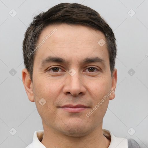 Joyful white adult male with short  brown hair and brown eyes