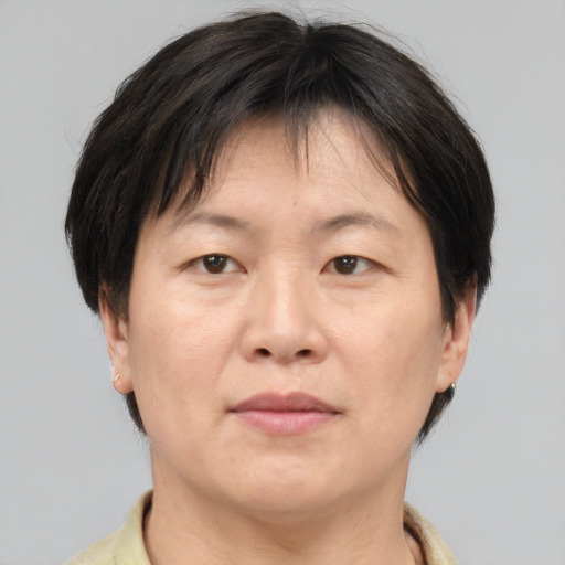 Joyful white adult female with short  brown hair and brown eyes