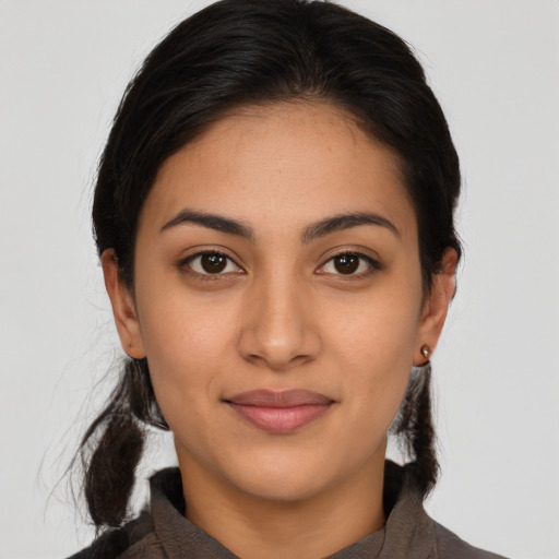 Joyful latino young-adult female with long  brown hair and brown eyes