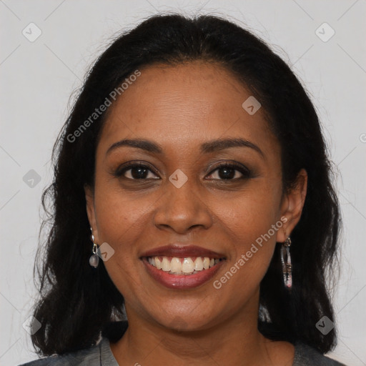 Joyful black young-adult female with long  brown hair and brown eyes