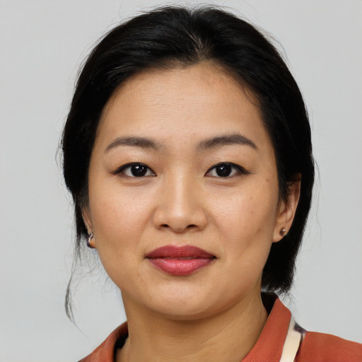 Joyful asian young-adult female with medium  black hair and brown eyes