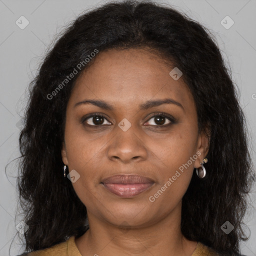 Joyful black young-adult female with long  brown hair and brown eyes