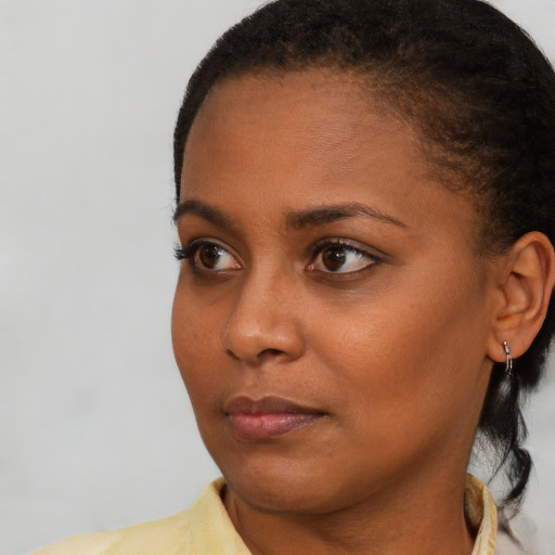 Neutral black young-adult female with short  brown hair and brown eyes