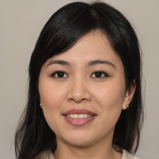 Joyful asian young-adult female with medium  brown hair and brown eyes