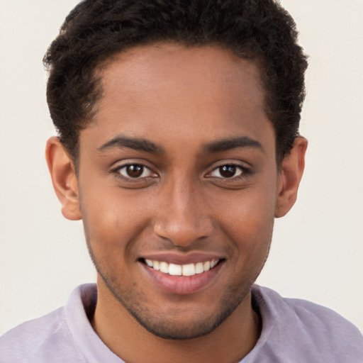 Joyful black young-adult male with short  brown hair and brown eyes