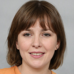 Joyful white adult female with medium  brown hair and grey eyes