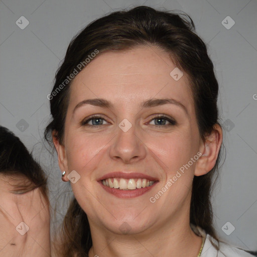 Joyful white adult female with medium  brown hair and blue eyes