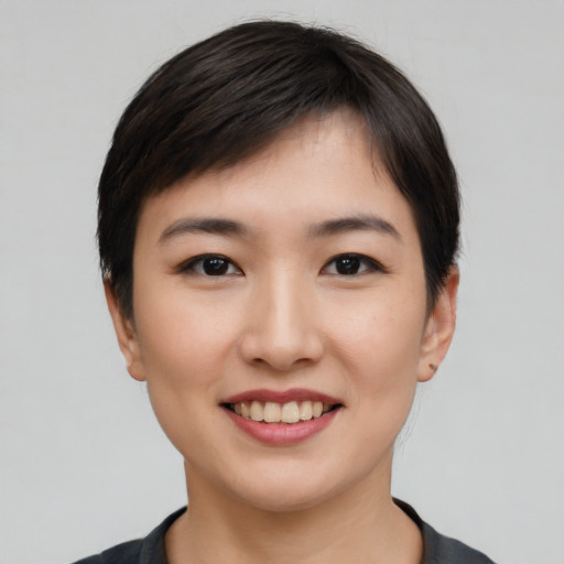 Joyful asian young-adult female with short  black hair and brown eyes