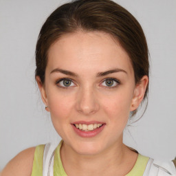 Joyful white young-adult female with medium  brown hair and blue eyes