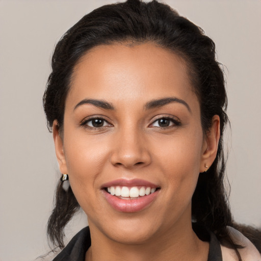 Joyful latino young-adult female with medium  brown hair and brown eyes