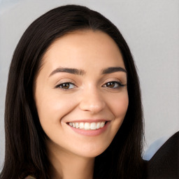 Joyful white young-adult female with long  black hair and brown eyes