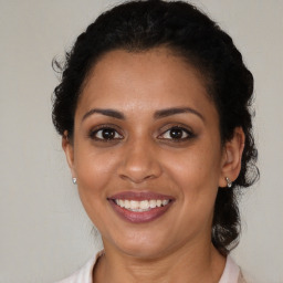 Joyful black young-adult female with medium  brown hair and brown eyes