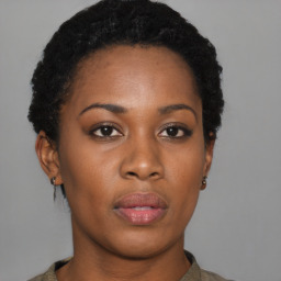 Joyful black young-adult female with short  black hair and brown eyes