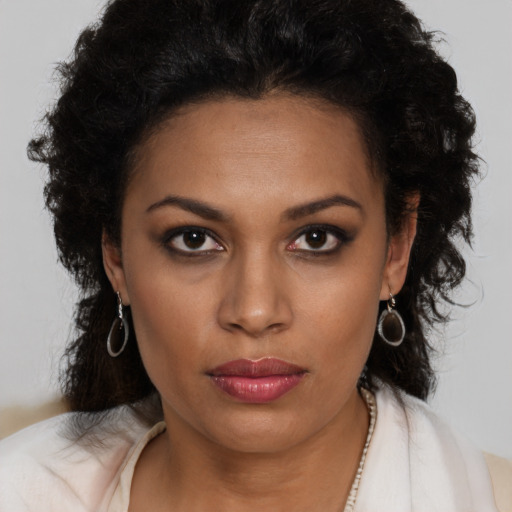 Neutral black young-adult female with long  brown hair and brown eyes
