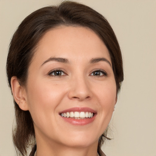 Joyful white young-adult female with medium  brown hair and brown eyes