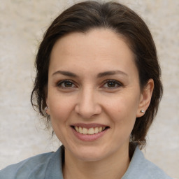 Joyful white adult female with medium  brown hair and brown eyes