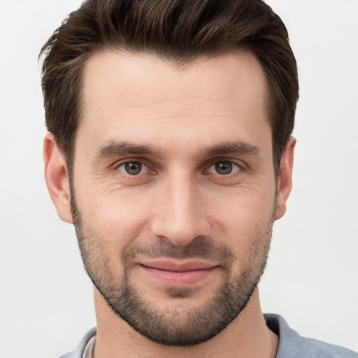 Joyful white young-adult male with short  brown hair and brown eyes