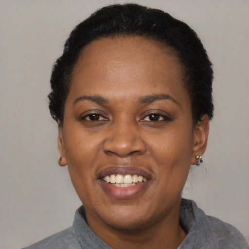 Joyful black adult female with short  black hair and brown eyes