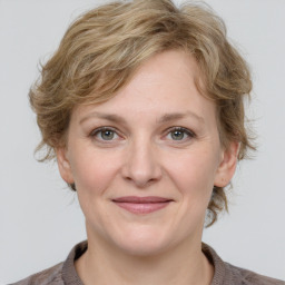 Joyful white adult female with medium  brown hair and grey eyes