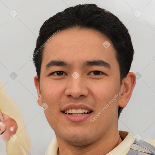 Joyful white young-adult male with short  black hair and brown eyes