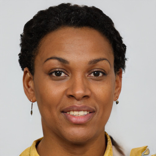 Joyful black young-adult female with short  brown hair and brown eyes