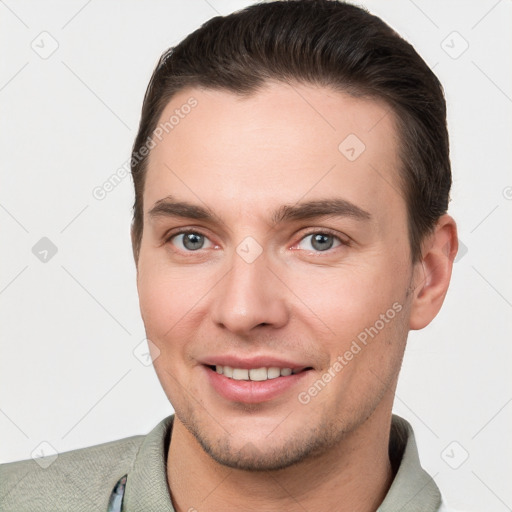 Joyful white young-adult male with short  brown hair and brown eyes